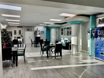 a view of a dining room with lots of furniture and wooden floor