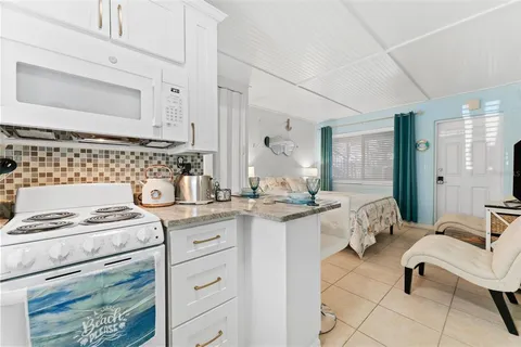 a kitchen with sink stove and cabinets