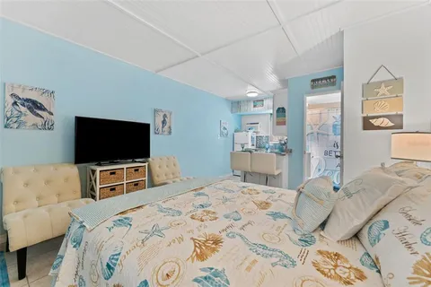 a bedroom with a bed and a flat screen tv