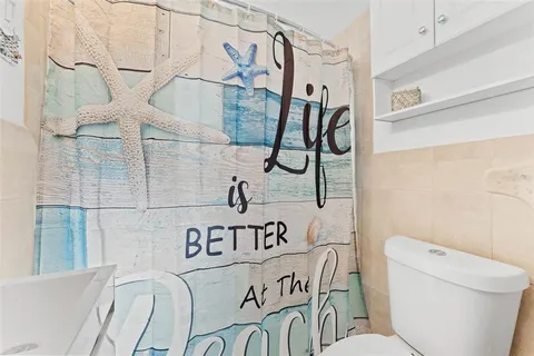 a bathroom with a toilet and a shower