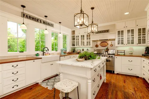 a kitchen with stainless steel appliances a stove sink and cabinets