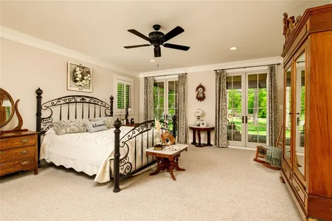 a bed room with a bed and a large window
