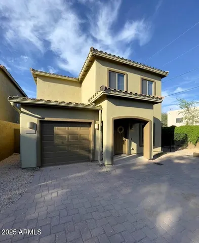 a view of a house with a garage and fireplace
