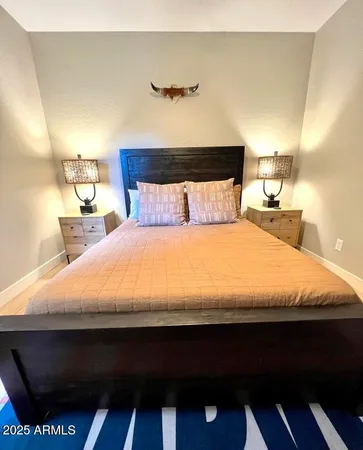 a large bed sitting in a bedroom next to a lamp