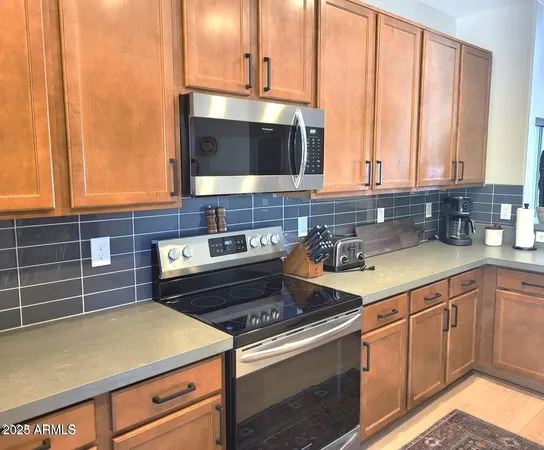 a kitchen with a sink stove and microwave