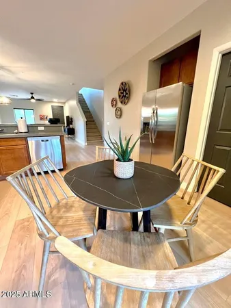 a dining room with furniture and wooden floor