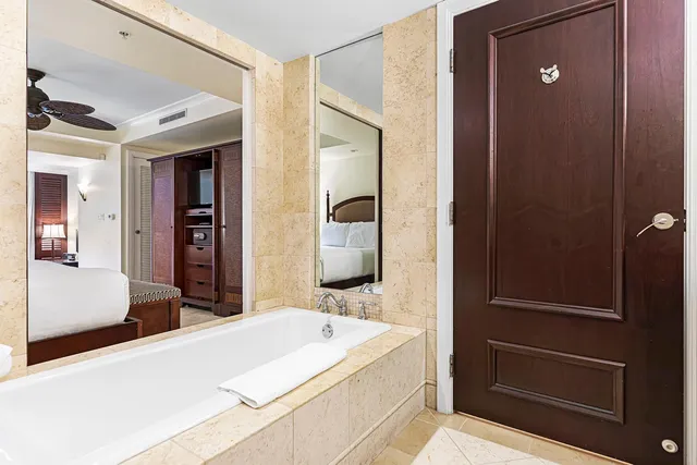 a bathroom with a granite countertop sink a toilet and shower