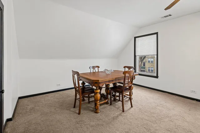a view of a dining room with furniture and window