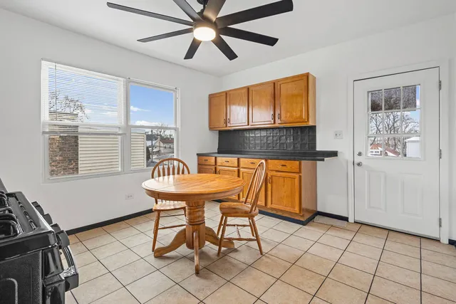 a balcony with chairs and window