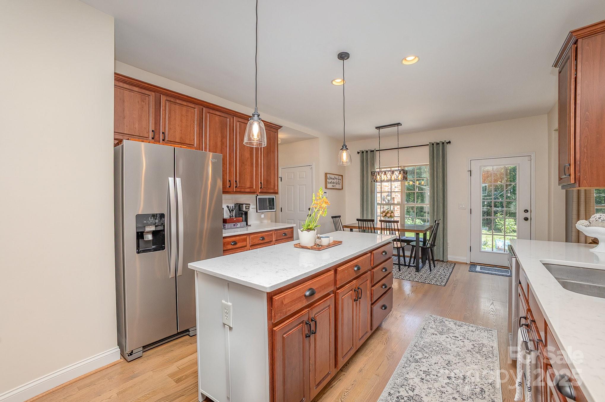 8121 Cane Pointe Lane Waxhaw, NC 28173 - Photo 15 of 39 a kitchen with stainless steel appliances a sink stove and refrigerator