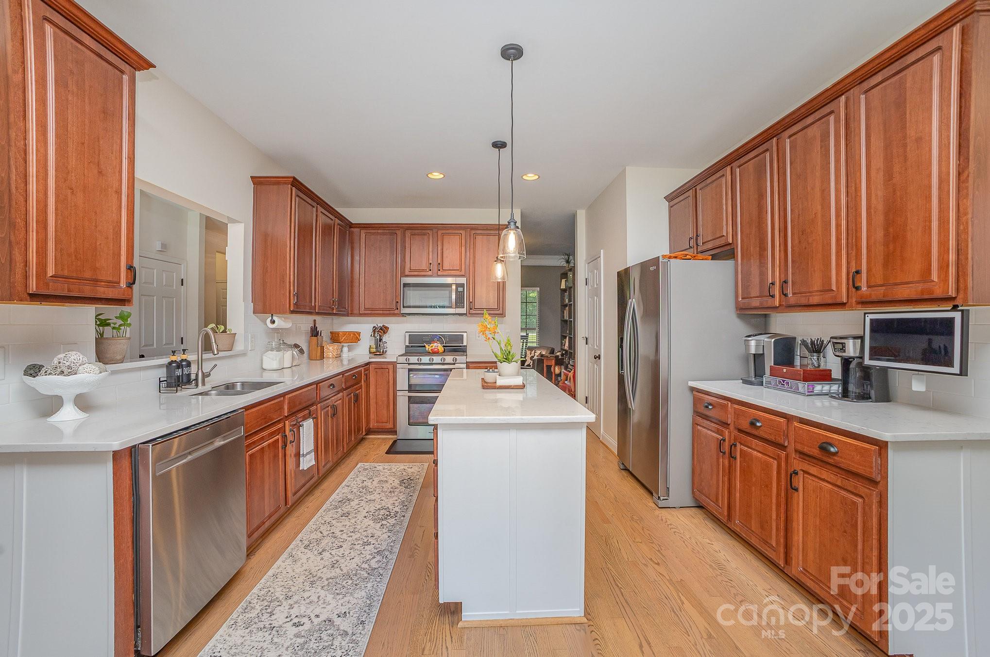 8121 Cane Pointe Lane Waxhaw, NC 28173 - Photo 17 of 39 a kitchen with a sink refrigerator and cabinets