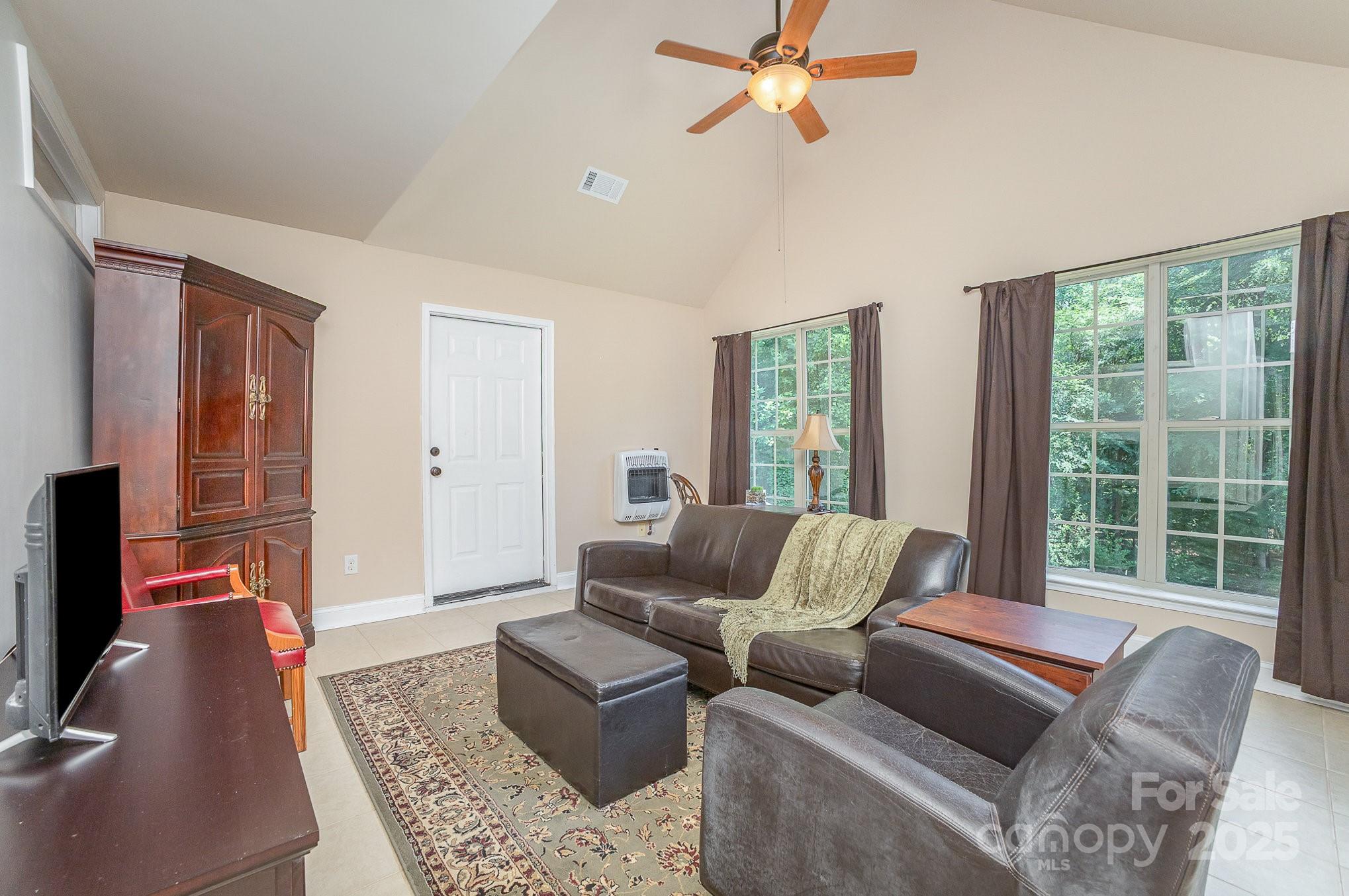8121 Cane Pointe Lane Waxhaw, NC 28173 - Photo 18 of 39 a living room with furniture and a flat screen tv
