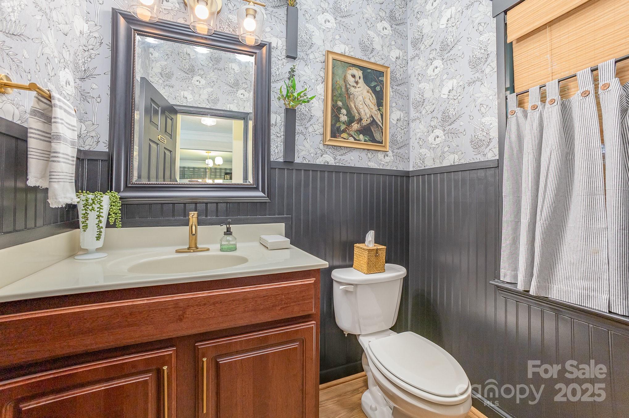 8121 Cane Pointe Lane Waxhaw, NC 28173 - Photo 19 of 39 a bathroom with a sink a toilet and a mirror