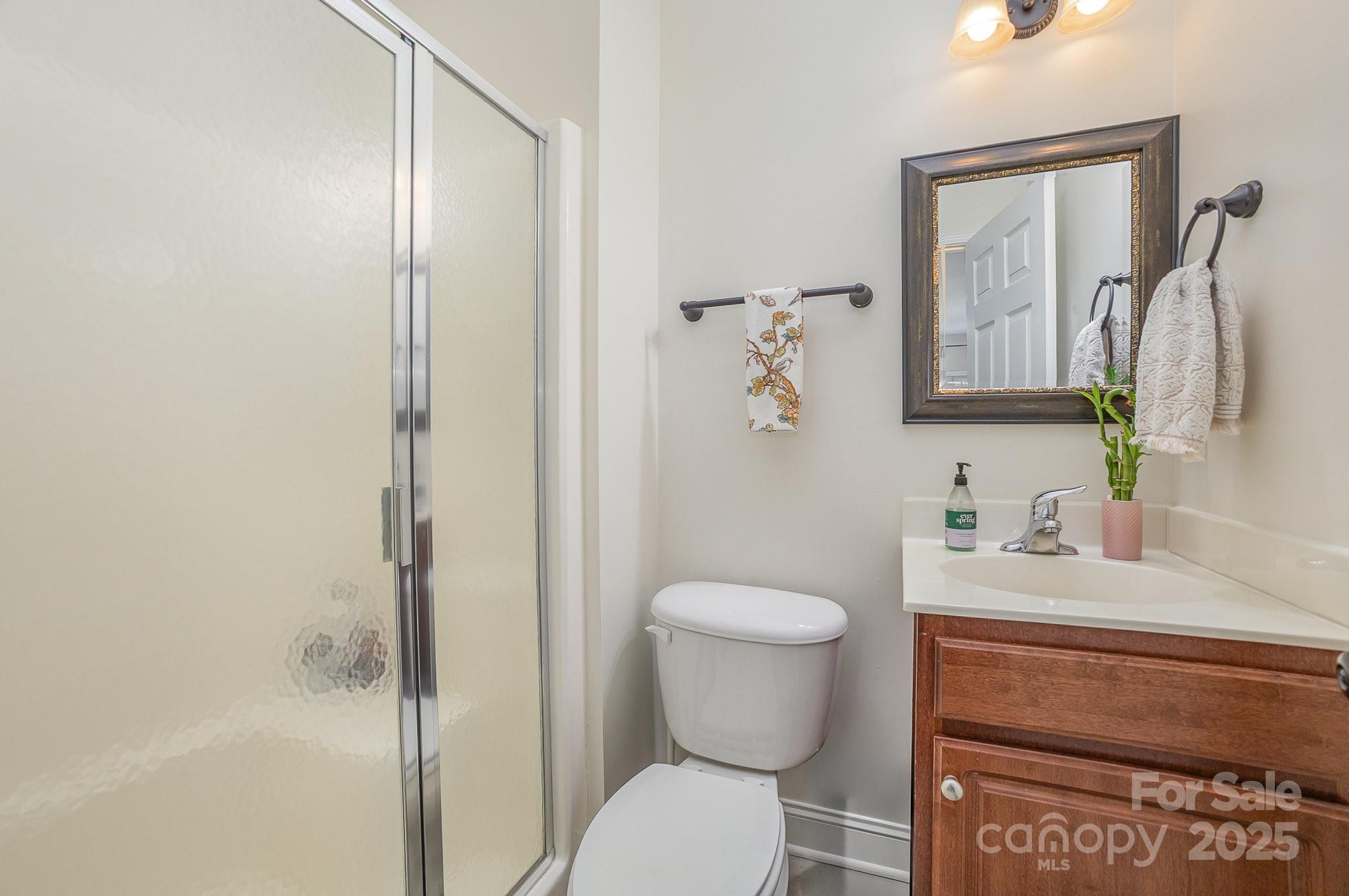 8121 Cane Pointe Lane Waxhaw, NC 28173 - Photo 20 of 39 a bathroom with a toilet sink and shower