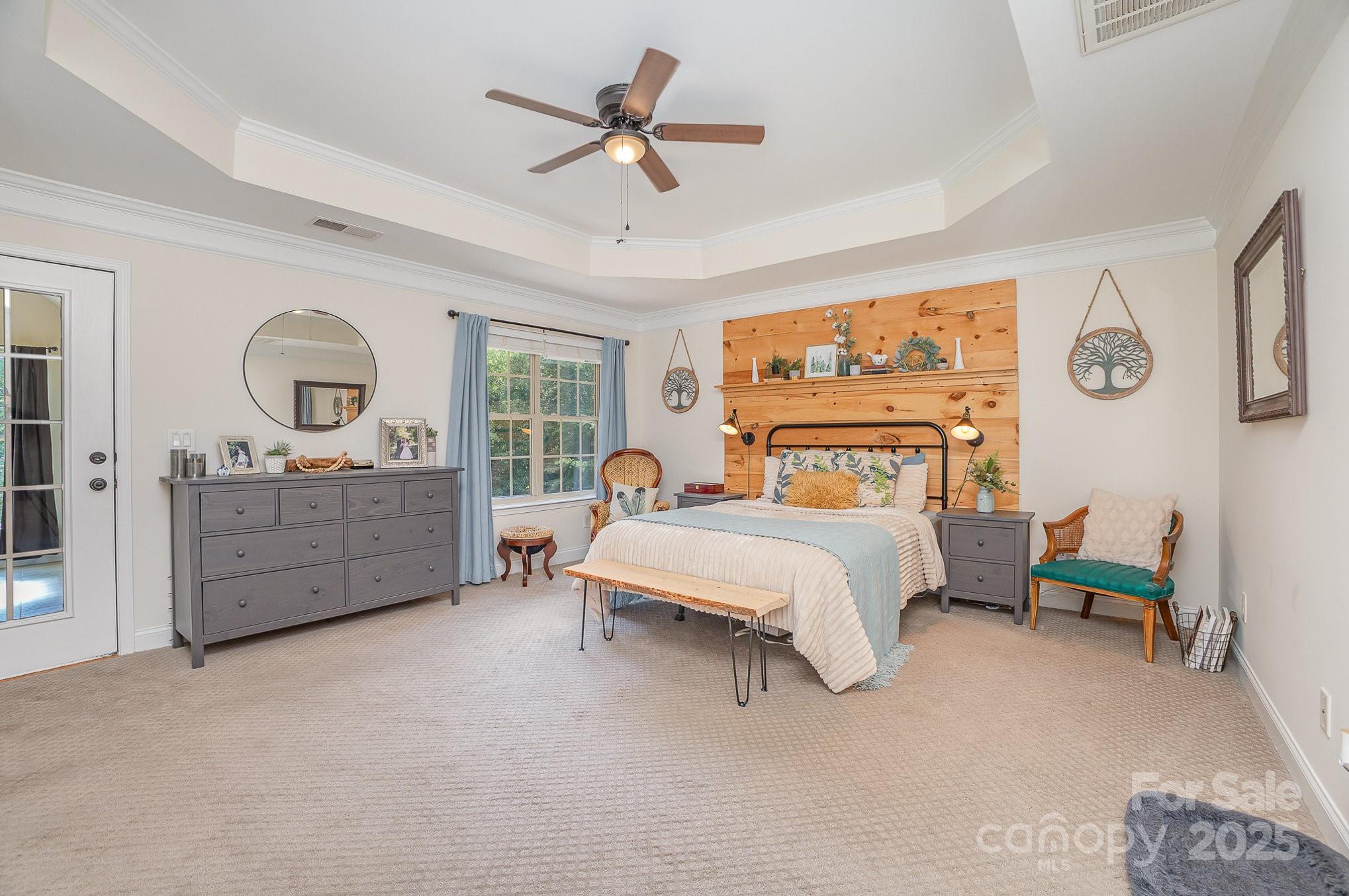 8121 Cane Pointe Lane Waxhaw, NC 28173 - Photo 21 of 39 a spacious bedroom with a bed a dresser and next to a window