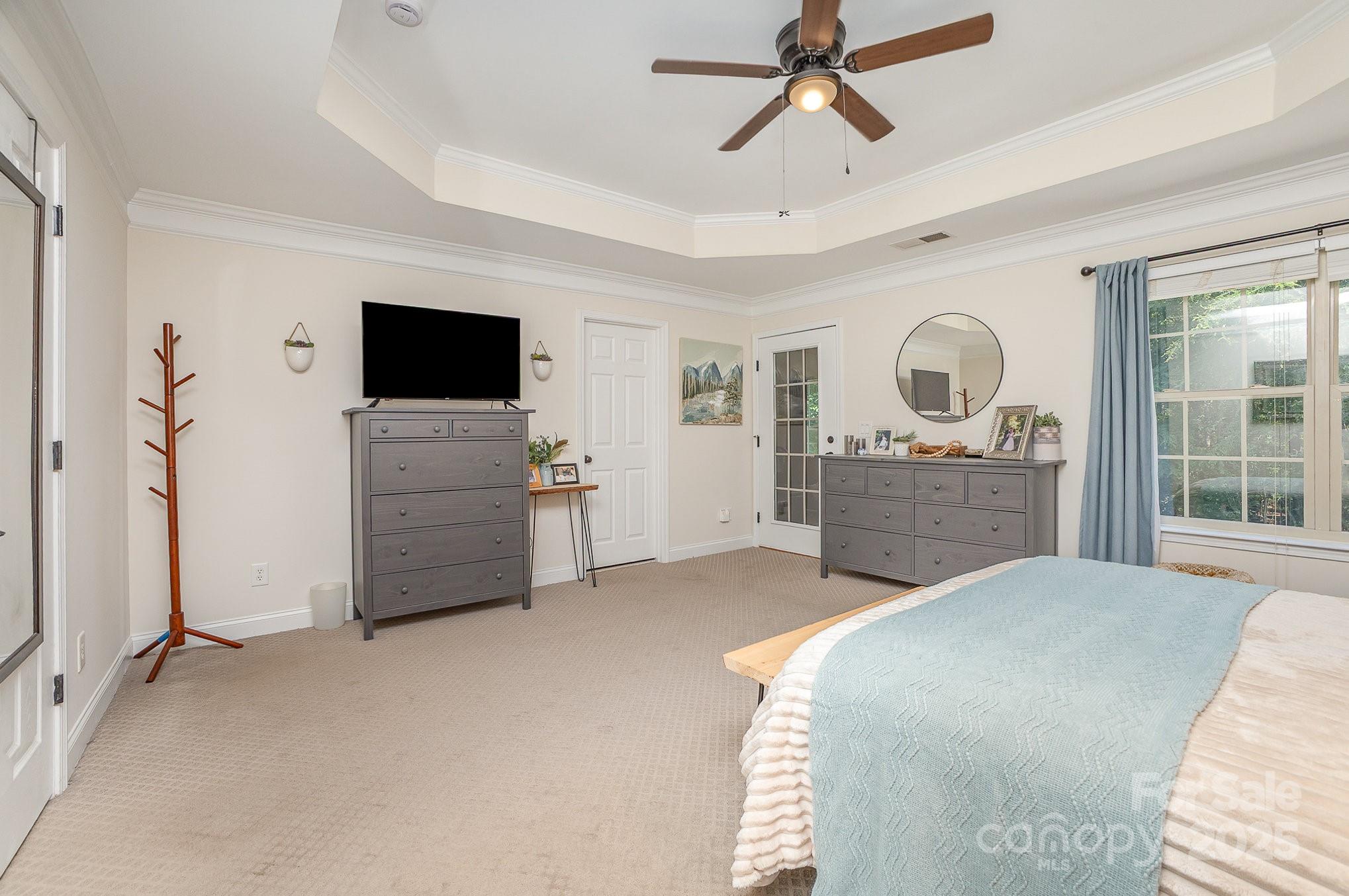 8121 Cane Pointe Lane Waxhaw, NC 28173 - Photo 22 of 39 a spacious bedroom with a bed and a flat screen tv