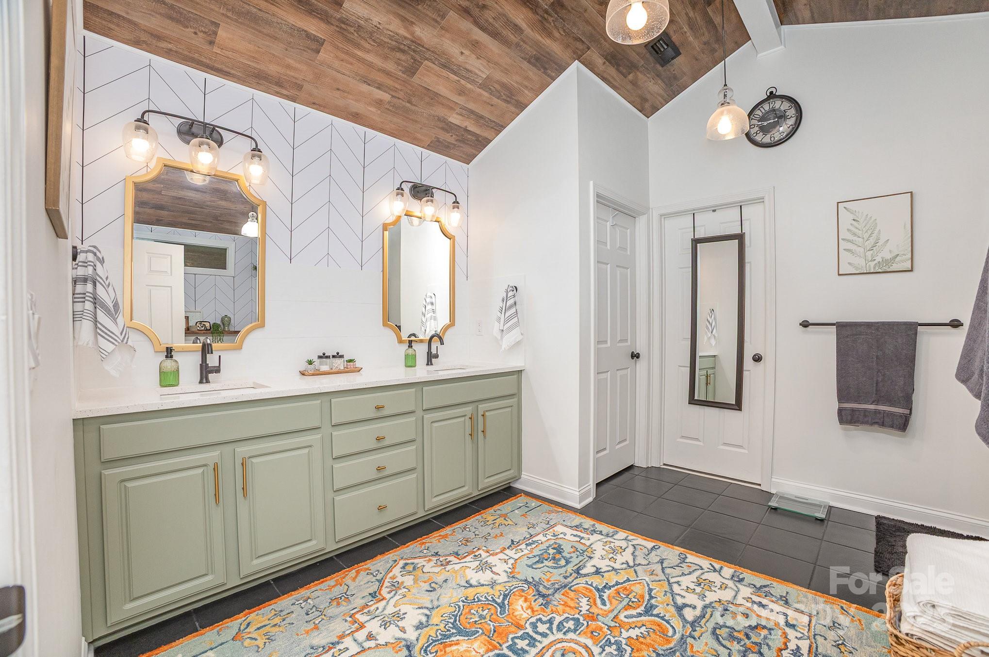 8121 Cane Pointe Lane Waxhaw, NC 28173 - Photo 23 of 39 a spacious bathroom with a double vanity sink and a mirror