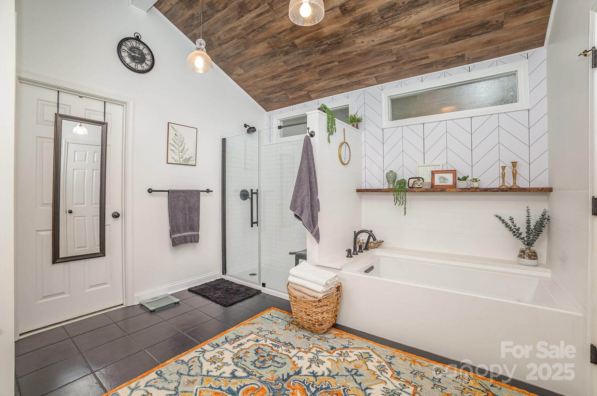 8121 Cane Pointe Lane Waxhaw, NC 28173 - Photo 24 of 39 a bathroom with a bathtub and a shower