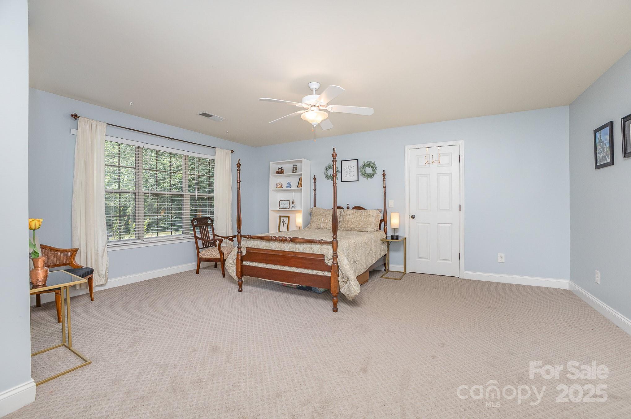 8121 Cane Pointe Lane Waxhaw, NC 28173 - Photo 27 of 39 a bedroom with furniture and a large window