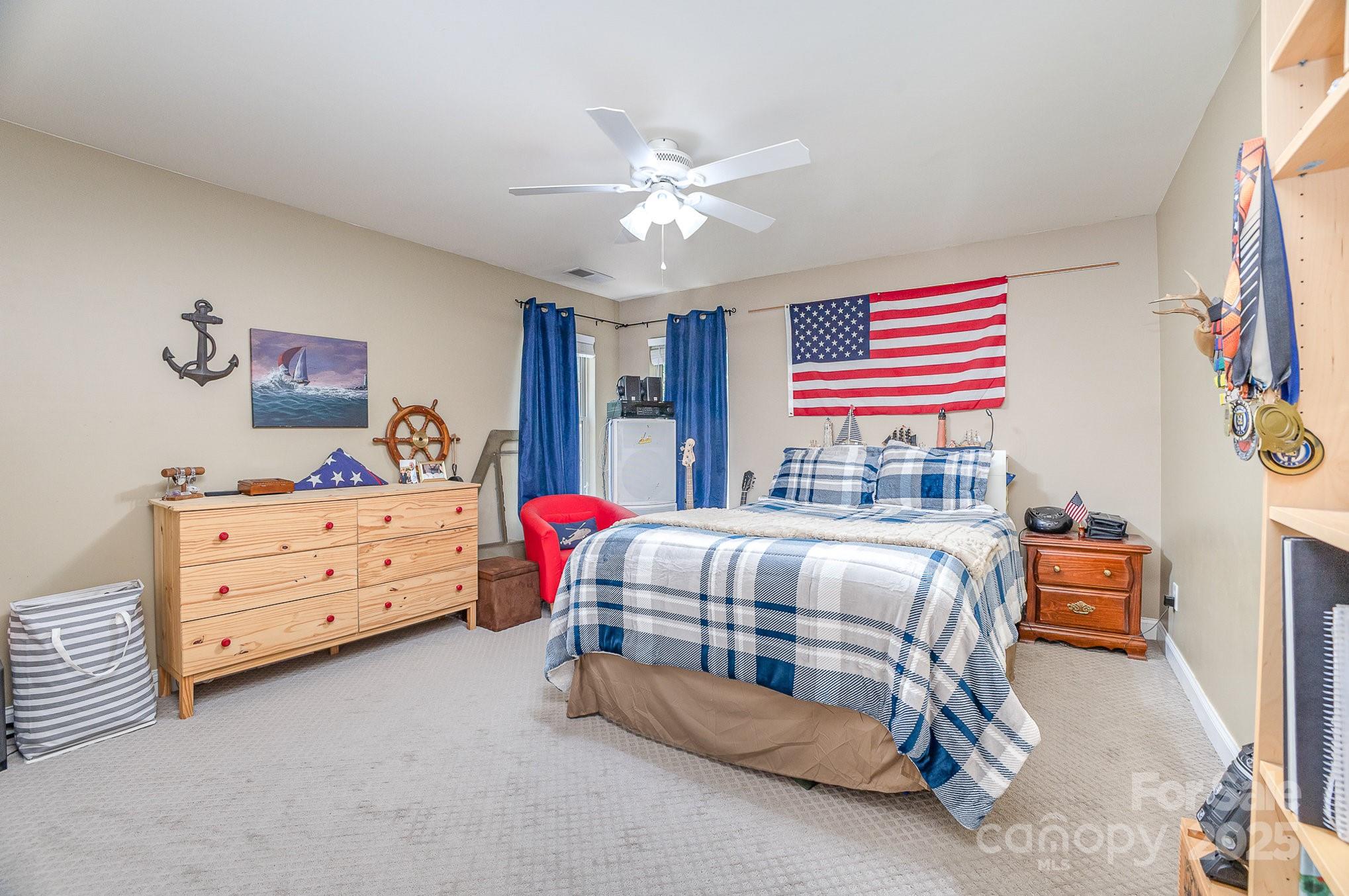 8121 Cane Pointe Lane Waxhaw, NC 28173 - Photo 28 of 39 a bedroom with two beds and a chandelier