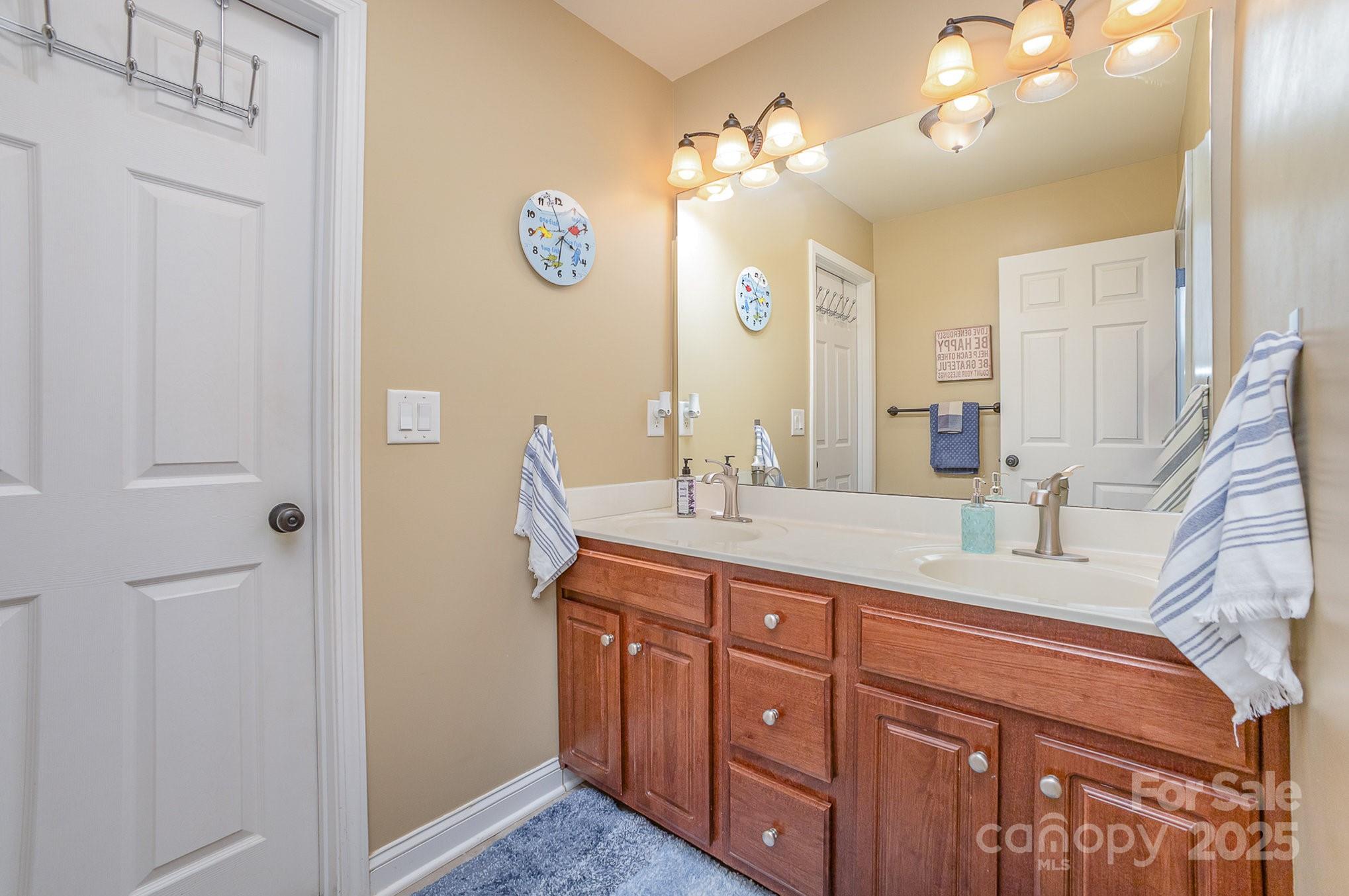8121 Cane Pointe Lane Waxhaw, NC 28173 - Photo 29 of 39 a bathroom with a sink a vanity and a mirror