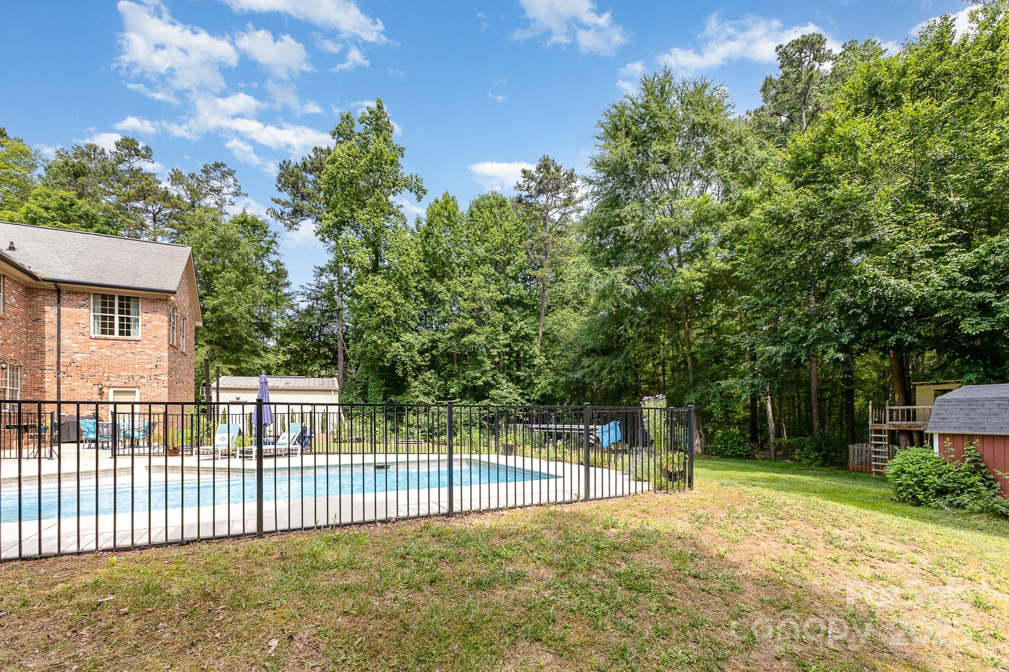 8121 Cane Pointe Lane Waxhaw, NC 28173 - Photo 32 of 39 a view of a backyard with a large tree