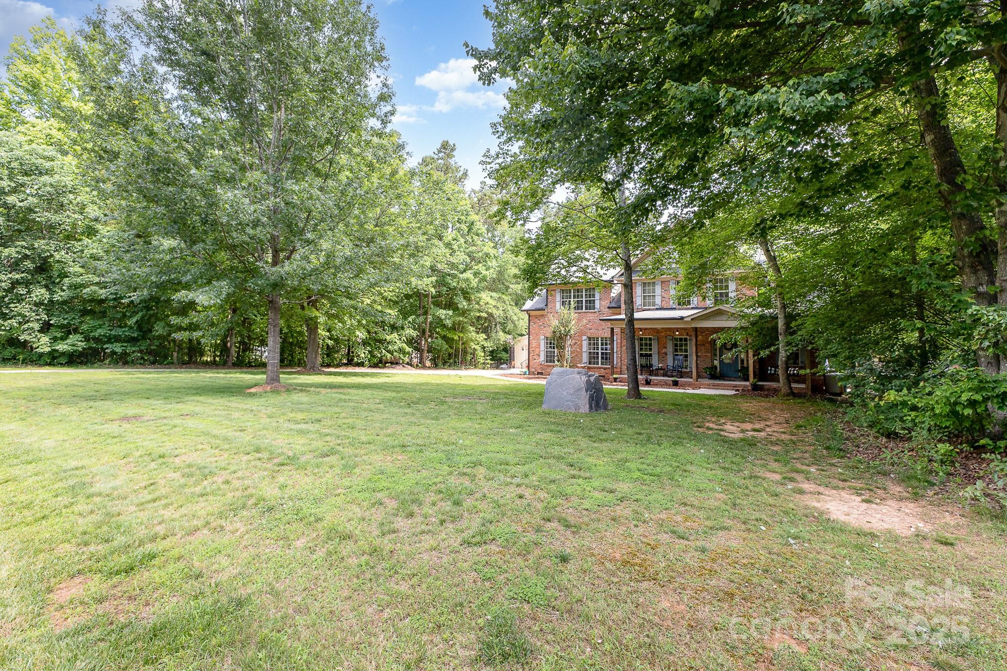 8121 Cane Pointe Lane Waxhaw, NC 28173 - Photo 5 of 39 a view of a house with backyard and trees