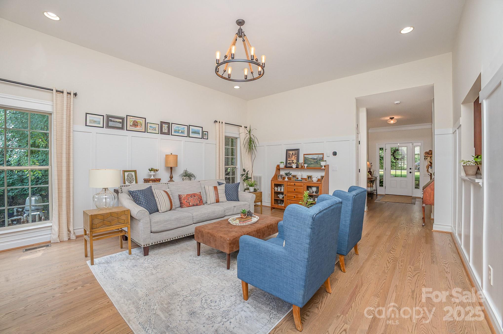 8121 Cane Pointe Lane Waxhaw, NC 28173 - Photo 10 of 39 a living room with furniture and a chandelier