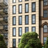 a view of a building and car parked on the street