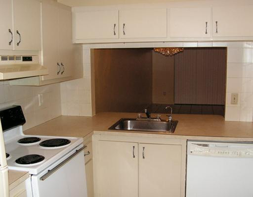 5296 Gate Lake Road, Unit 5296 Tamarac, FL 33319 - Photo 4 of 16 a kitchen with a sink a stove and cabinets