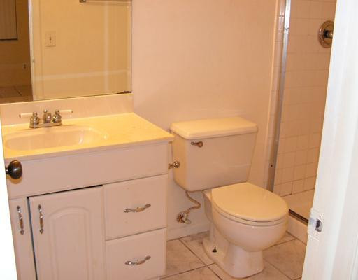 5296 Gate Lake Road, Unit 5296 Tamarac, FL 33319 - Photo 10 of 16 a bathroom with a sink a toilet and shower