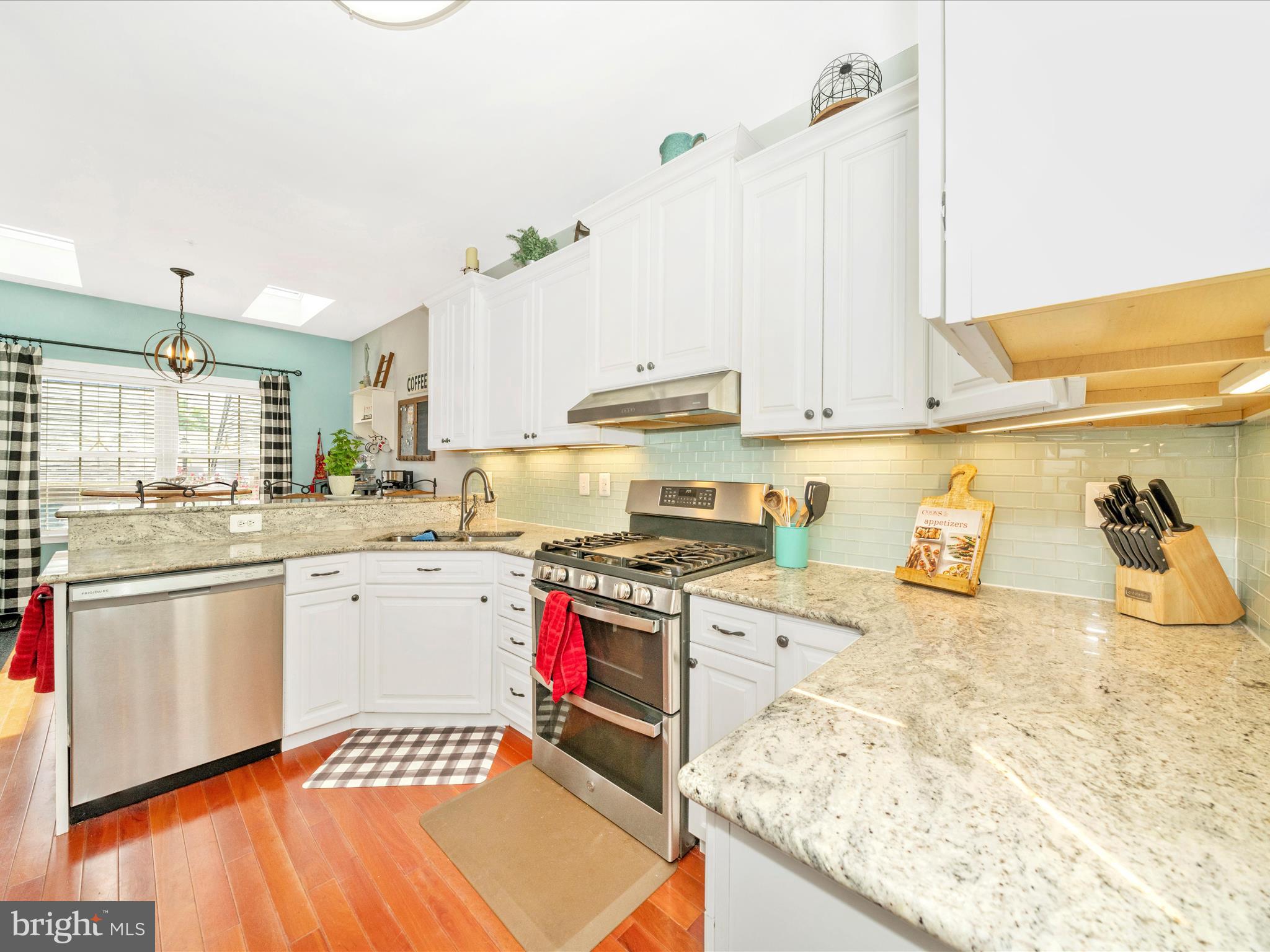 2529 Waterside Drive Frederick, MD 21701 - Photo 14 of 68 a kitchen with stainless steel appliances granite countertop a stove and white cabinets