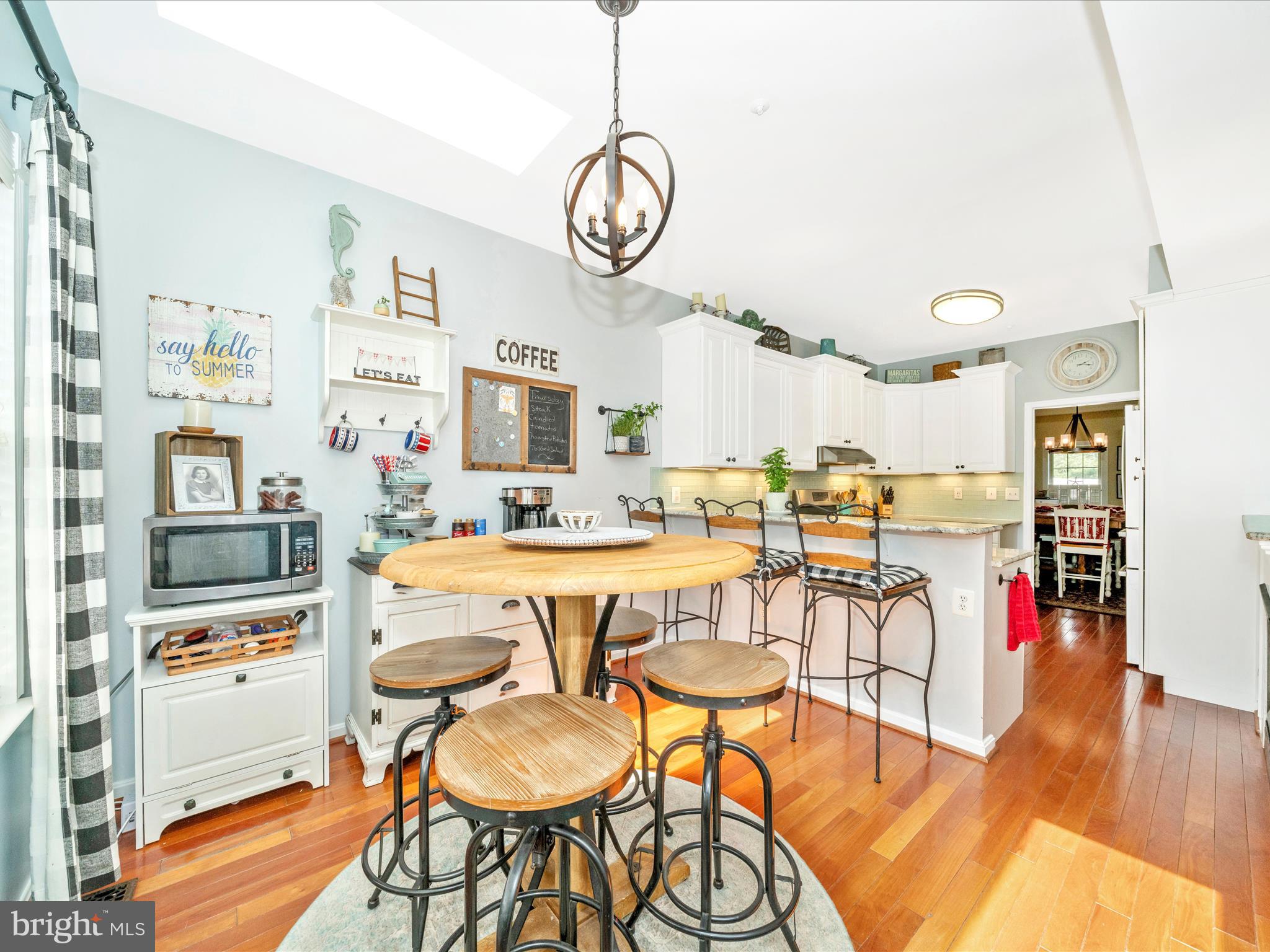 2529 Waterside Drive Frederick, MD 21701 - Photo 20 of 68 a very nice looking dining room with kitchen island stainless steel appliances a table and chairs