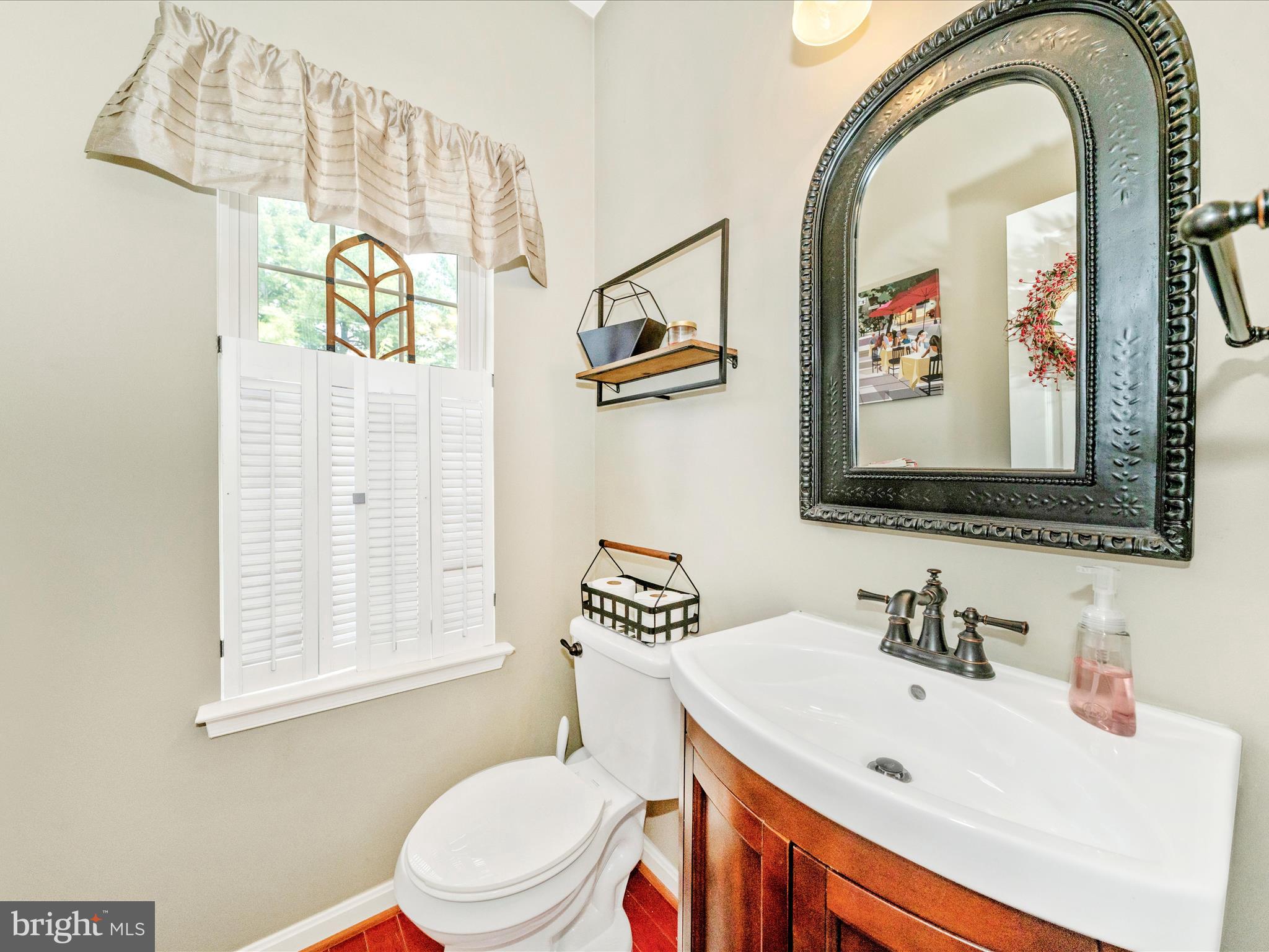 2529 Waterside Drive Frederick, MD 21701 - Photo 22 of 68 a bathroom with a sink a mirror a toilet and a window