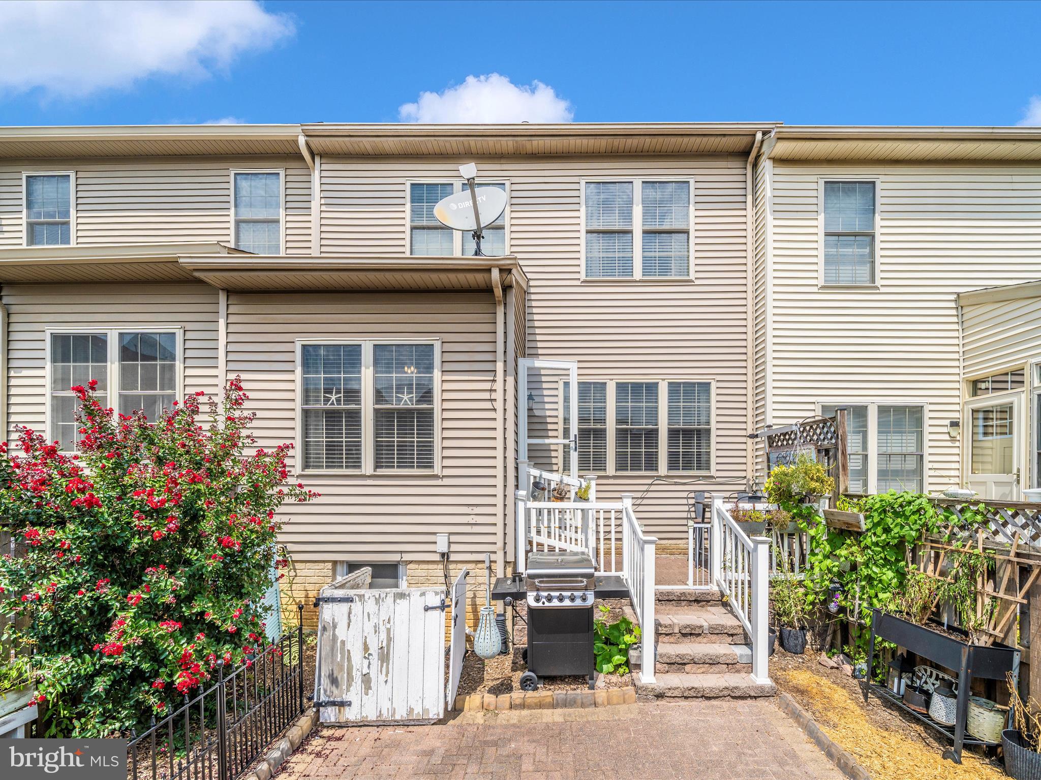 2529 Waterside Drive Frederick, MD 21701 - Photo 42 of 68 a front view of a house with a yard and potted plants