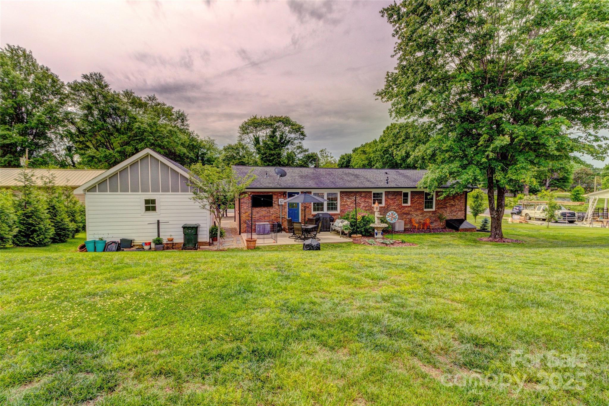 800 Sunset Road Cherryville, NC 28021 - Photo 17 of 20 a front view of a house with a garden and porch