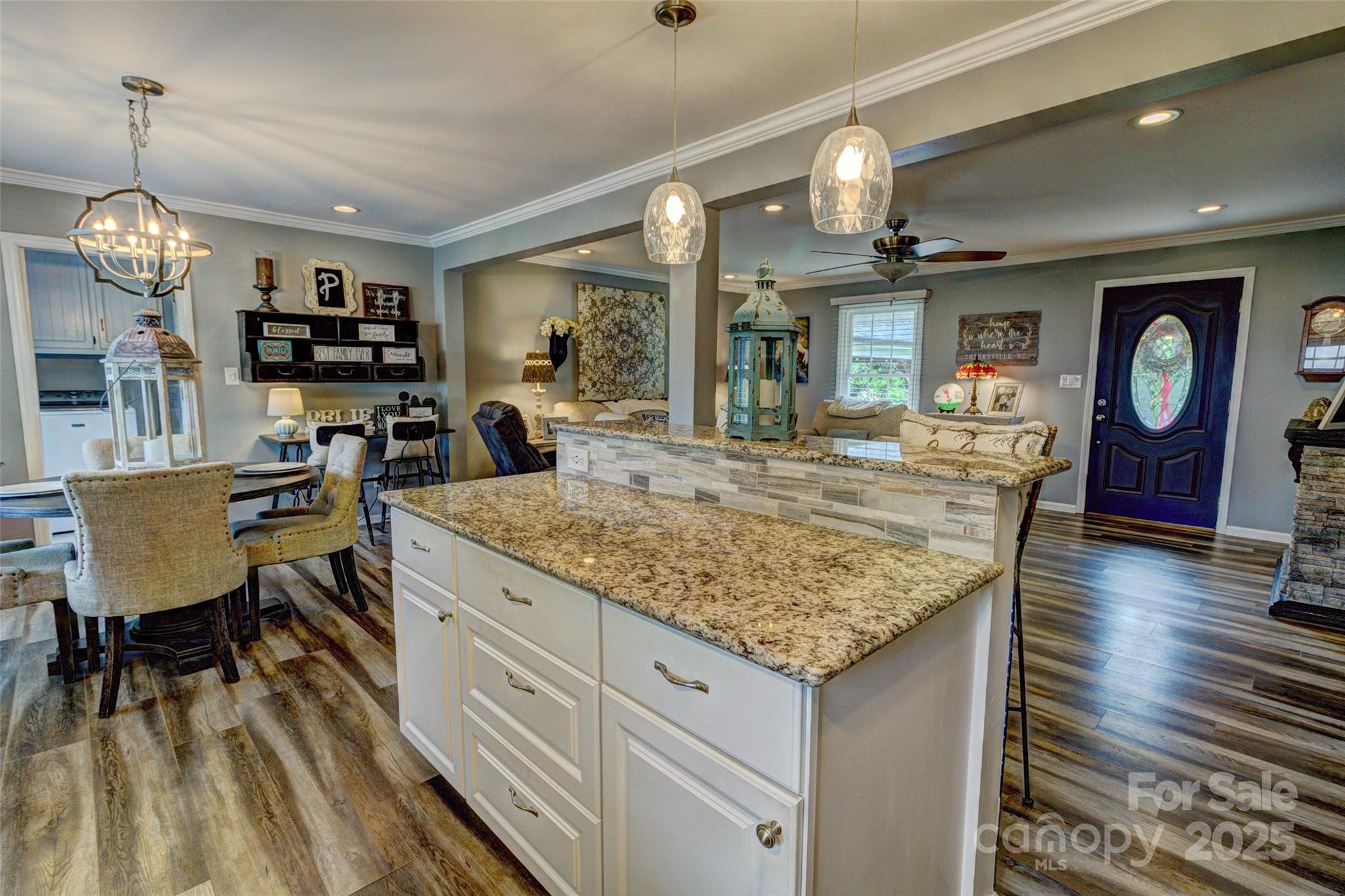 800 Sunset Road Cherryville, NC 28021 - Photo 9 of 20 a kitchen with granite countertop a stove and white cabinets with wooden floor