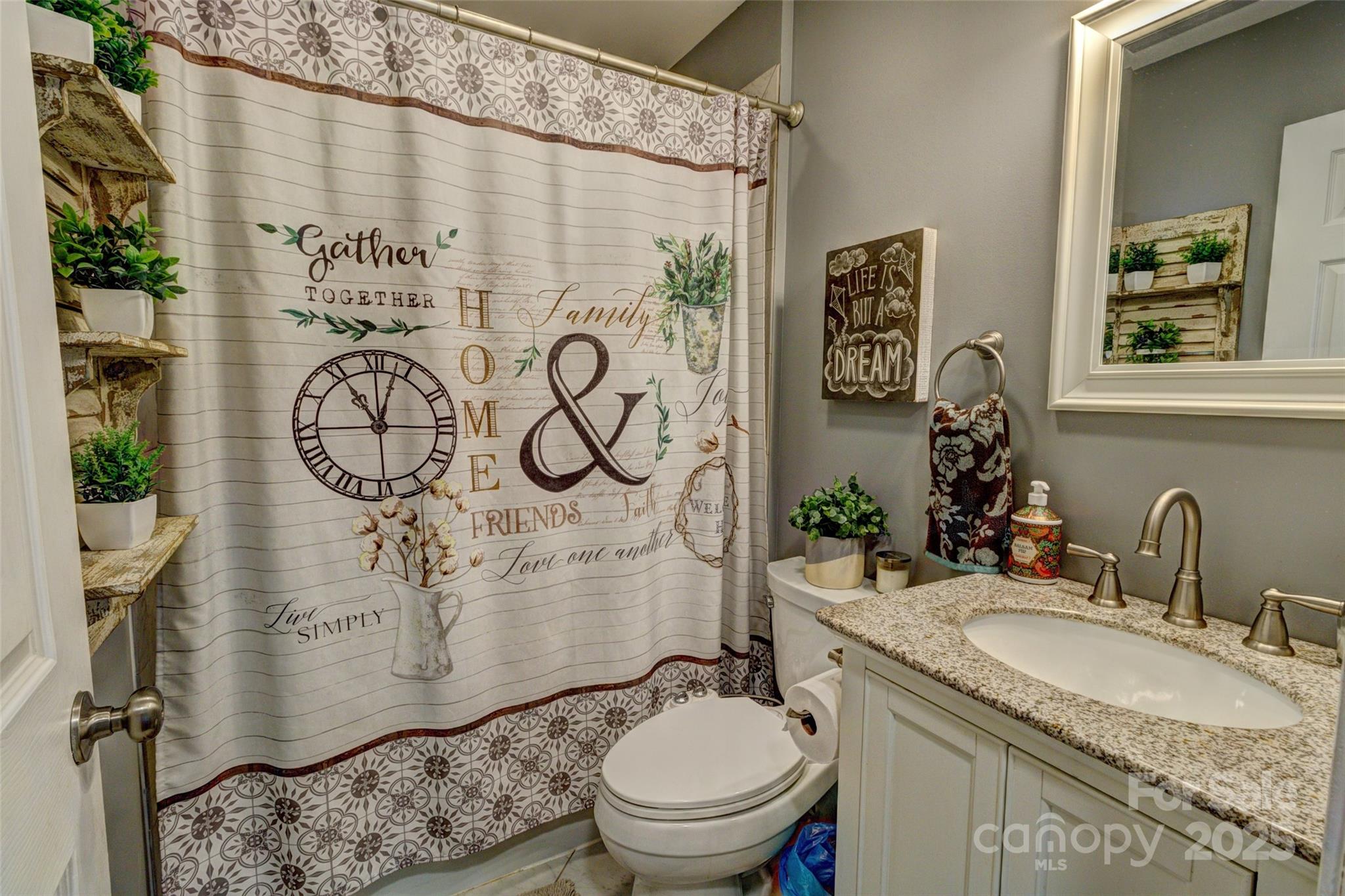 800 Sunset Road Cherryville, NC 28021 - Photo 10 of 20 a bathroom with a granite countertop sink a toilet and a mirror