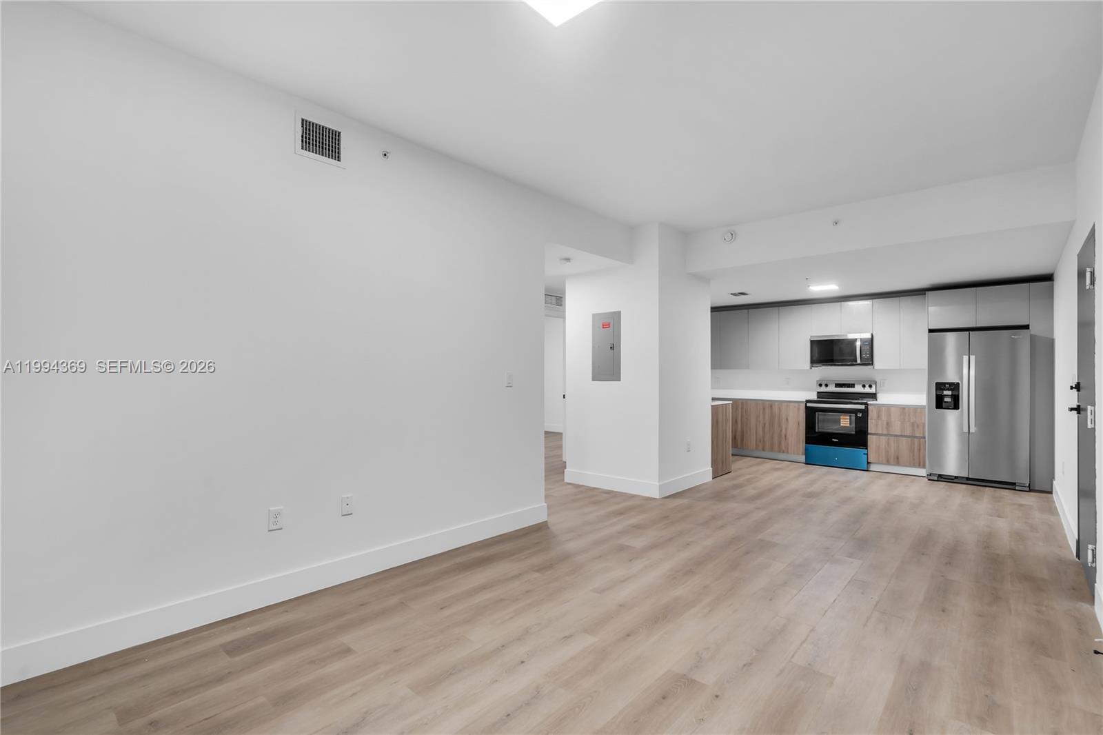 3728 Northwest 19th Avenue, Unit 101 Miami, FL 33142 - Photo 5 of 11 a view of kitchen with wooden floor