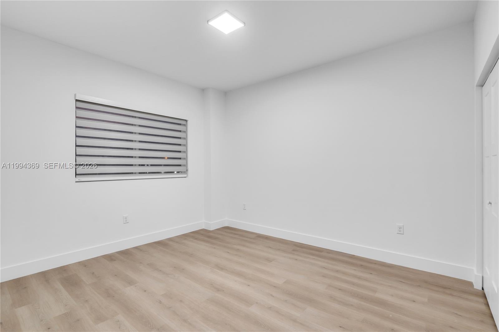 3728 Northwest 19th Avenue, Unit 101 Miami, FL 33142 - Photo 8 of 11 a view of empty room with wooden floor