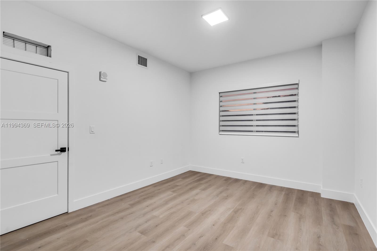 3728 Northwest 19th Avenue, Unit 101 Miami, FL 33142 - Photo 10 of 11 wooden floor in an empty room