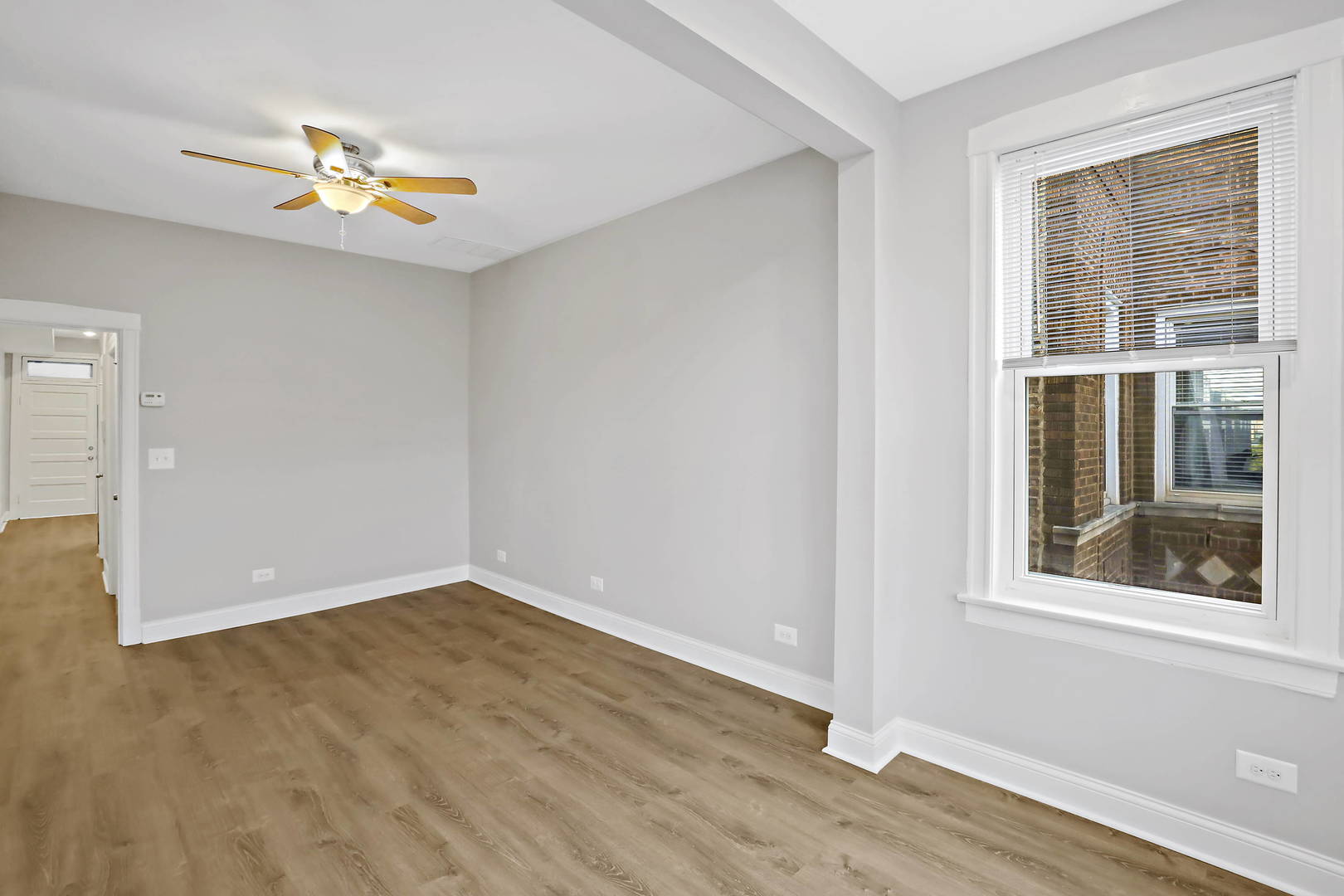 2626 North Ridgeway Avenue, Unit 1 Chicago, IL 60647 - Photo 14 of 16 a view of an empty room with wooden floor and a window