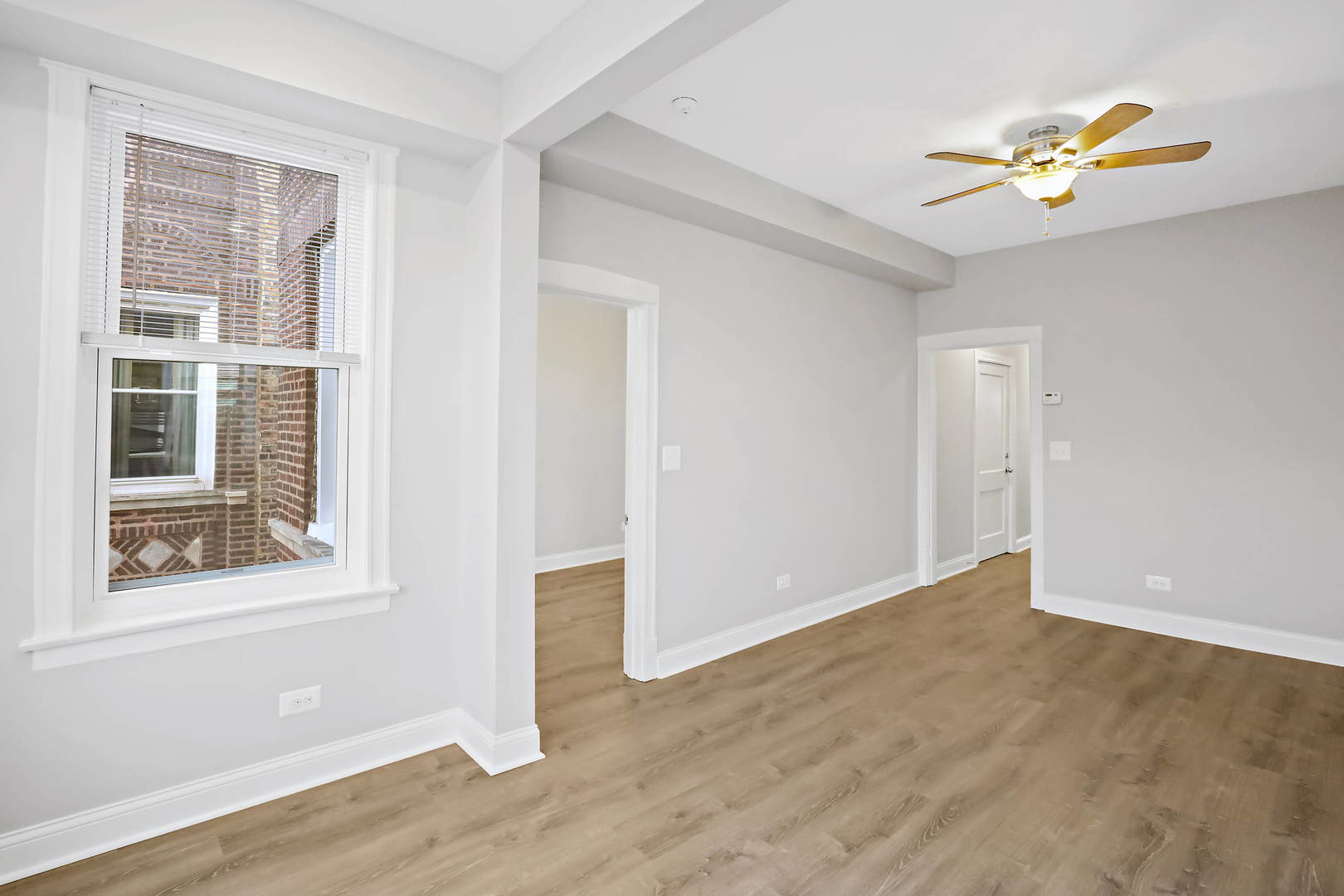 2626 North Ridgeway Avenue, Unit 1 Chicago, IL 60647 - Photo 15 of 16 a view of an empty room with a window and wooden floor