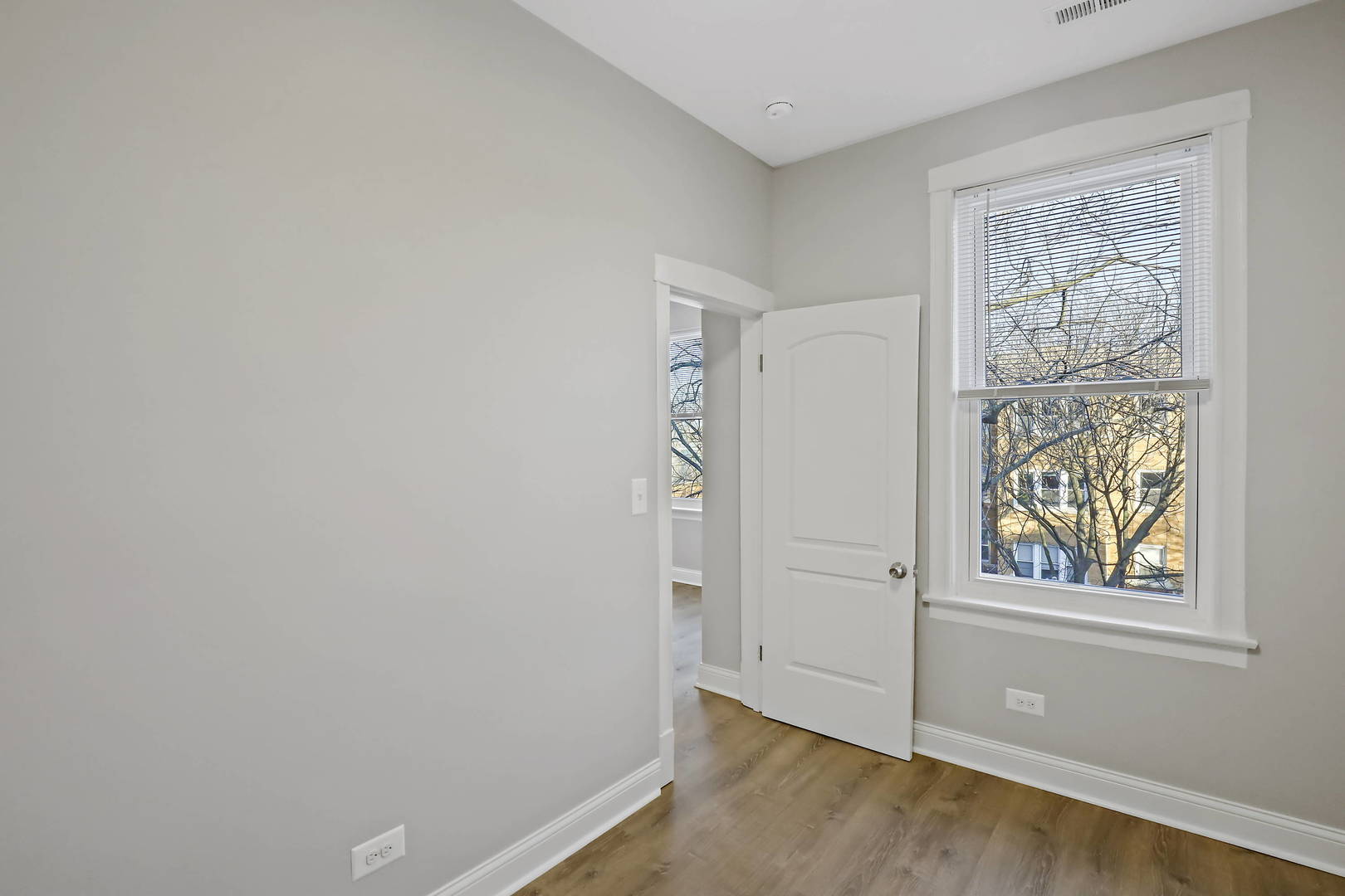 2626 North Ridgeway Avenue, Unit 1 Chicago, IL 60647 - Photo 16 of 16 an empty room with wooden floor and window
