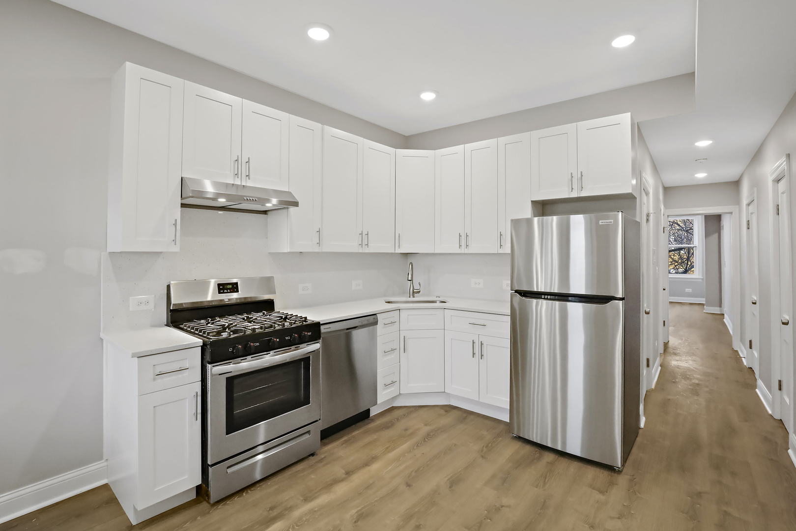 2626 North Ridgeway Avenue, Unit 1 Chicago, IL 60647 - Photo 2 of 16 a kitchen with stainless steel appliances granite countertop a refrigerator a stove a sink and white cabinets