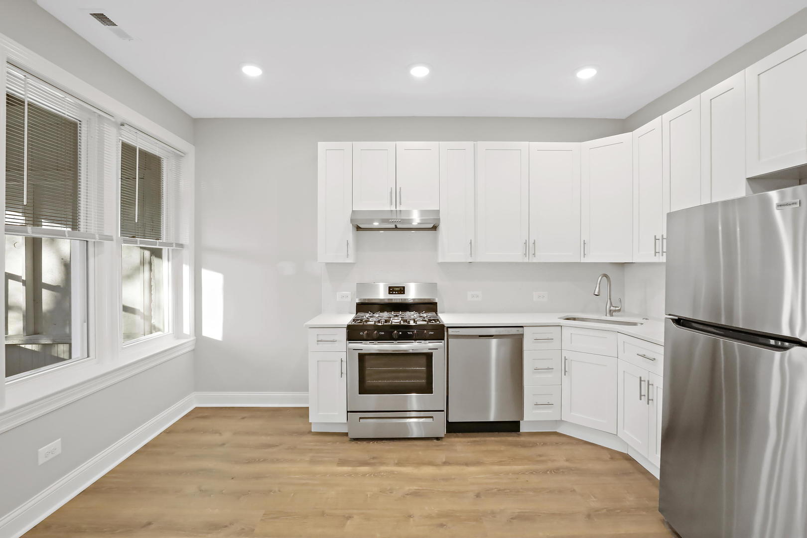 2626 North Ridgeway Avenue, Unit 1 Chicago, IL 60647 - Photo 3 of 16 a kitchen with a stove a refrigerator and a sink