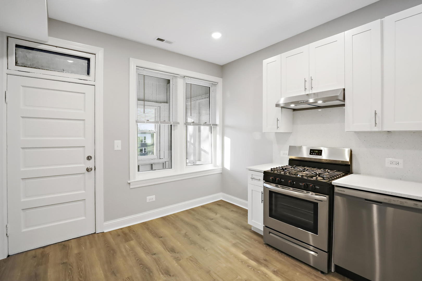 2626 North Ridgeway Avenue, Unit 1 Chicago, IL 60647 - Photo 4 of 16 a kitchen with white cabinets and appliances
