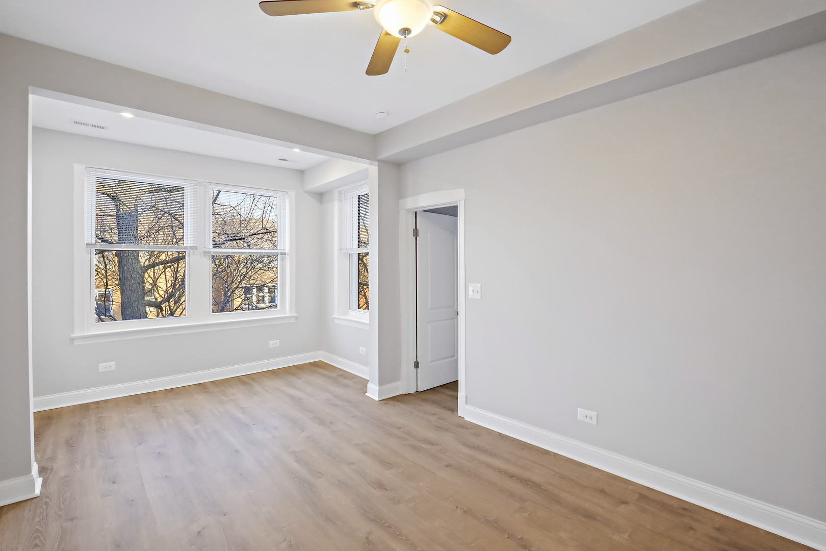 2626 North Ridgeway Avenue, Unit 1 Chicago, IL 60647 - Photo 6 of 16 wooden floor in an empty room with a window