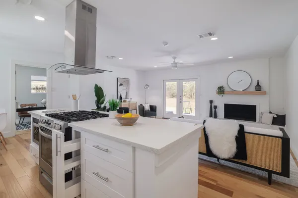 a kitchen with stainless steel appliances granite countertop a stove a sink and a refrigerator