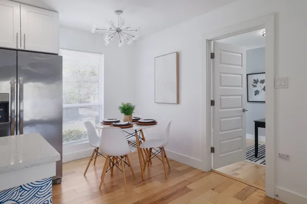 a view of a dining room with furniture and a chandelier fan